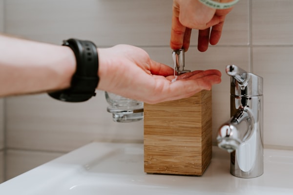 Professional plumber holding silver faucet during installation