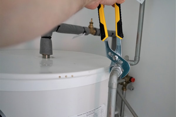 Professional plumber holding wrench tool for general plumbing work
