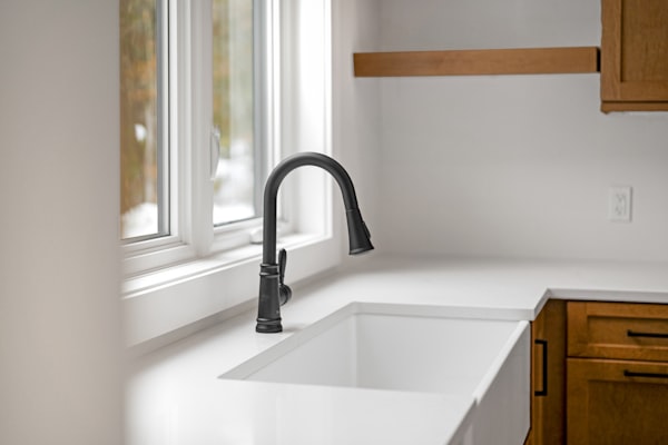 Modern kitchen sink with black faucet installation